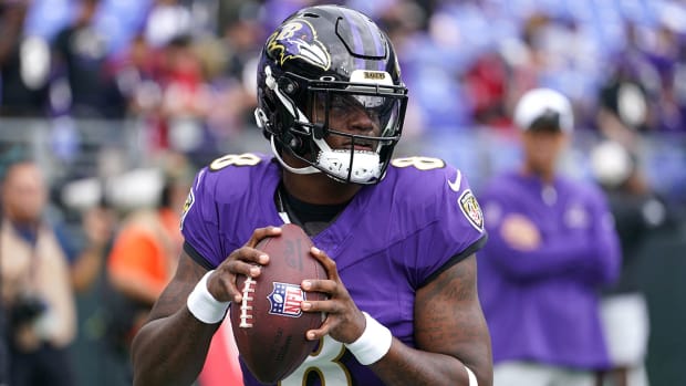Lamar Jackson holds the ball and looks ready to throw during pregame warmups